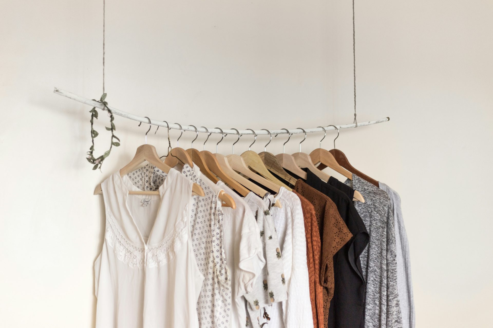 Rack with hanging clothes in neutral tones