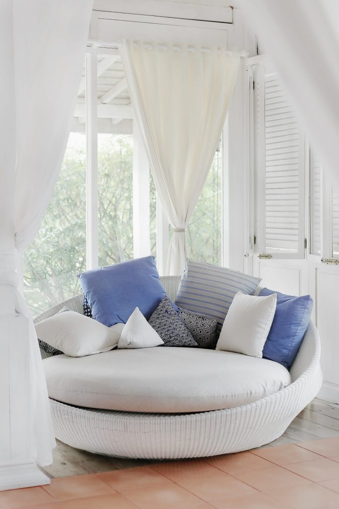 Cozy round sofa with blue and white pillows