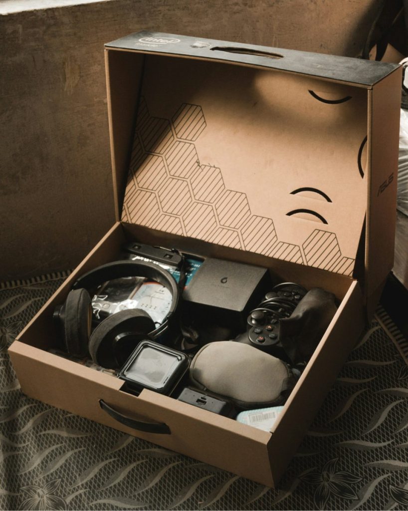 Box containing various electronic gadgets and accessories.