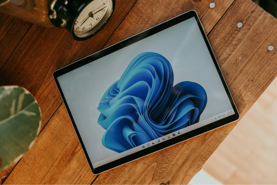 Tablet displaying blue abstract image on desk